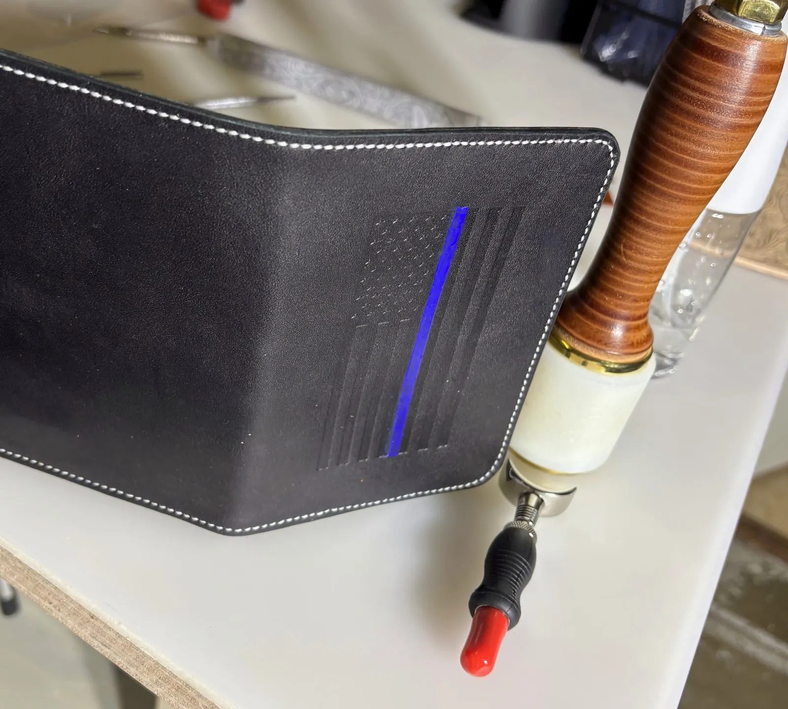 Black leather passport wallet with embossed flag and thin blue line