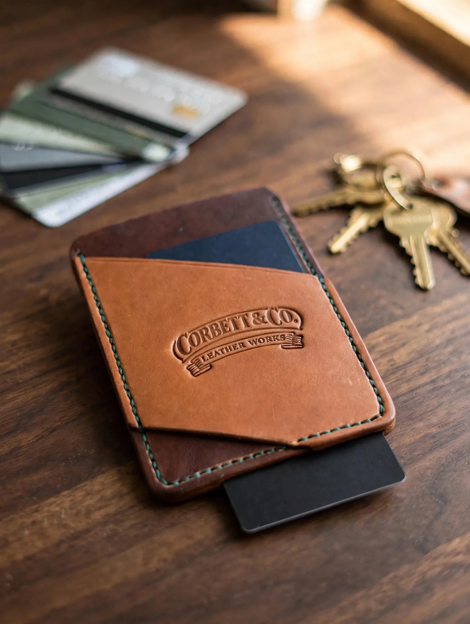 Card wallet with cards and keys on desk