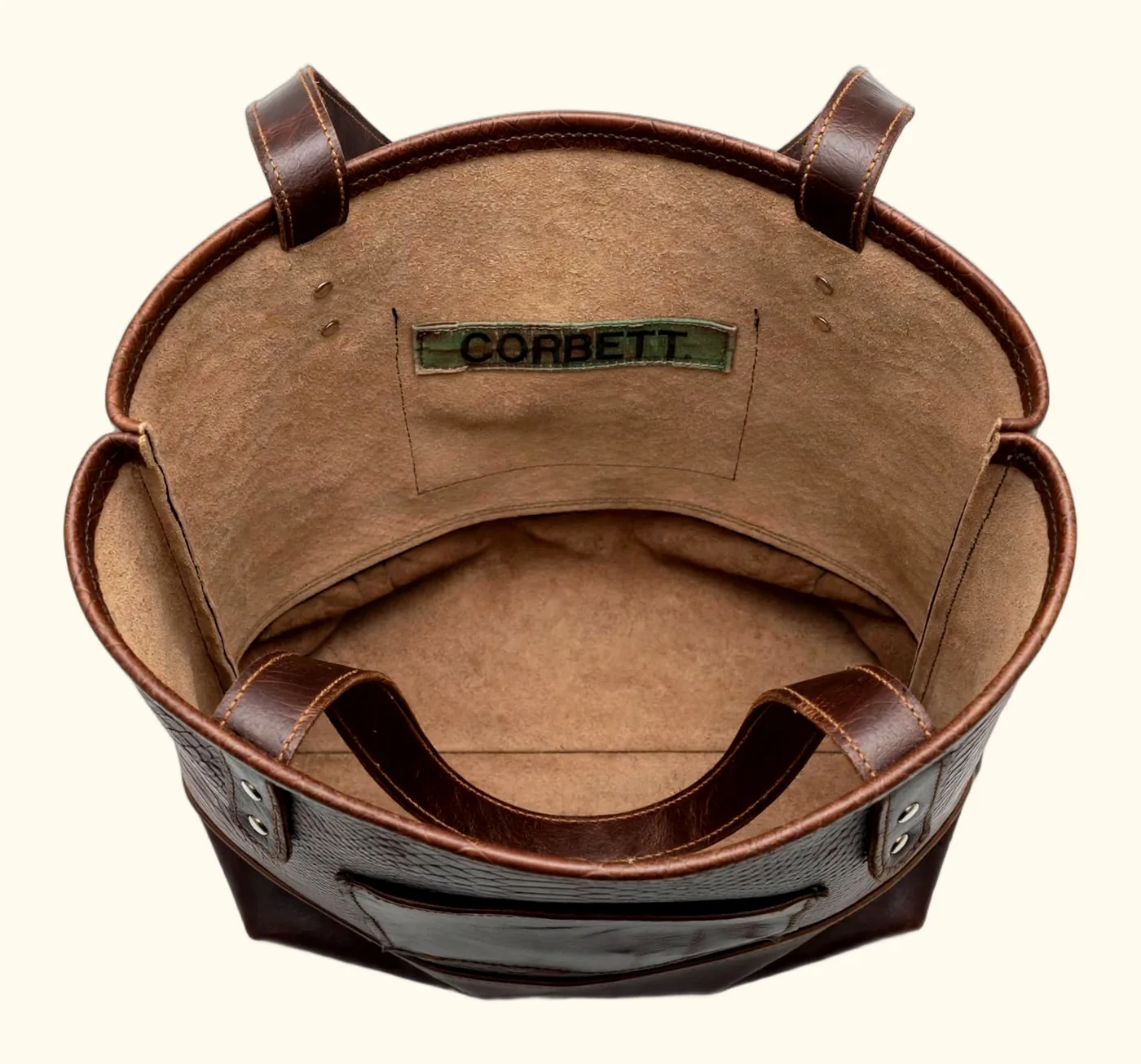 Interior of large leather tote with suede lining, slip pocket, and Corbett maker's label