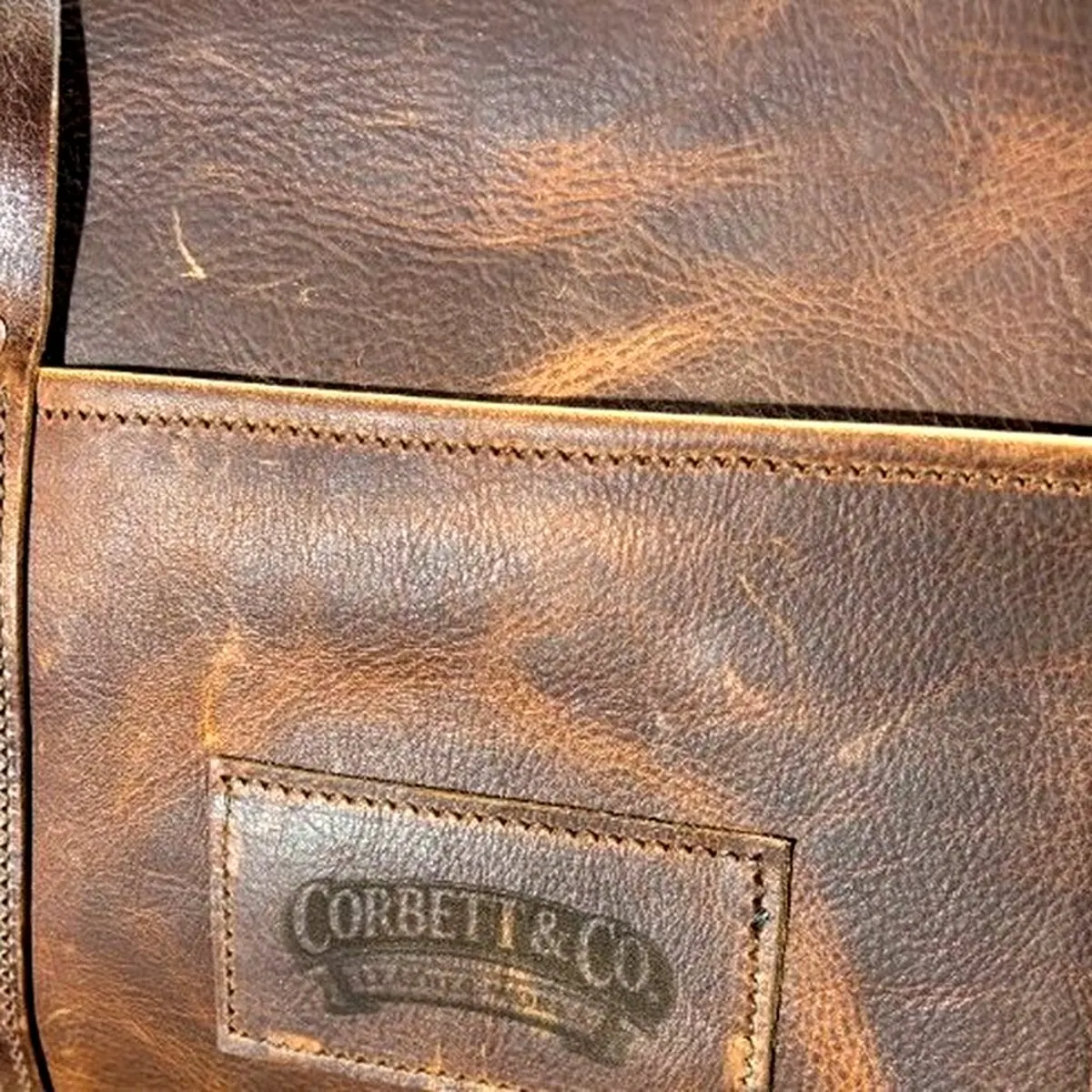 Embossed Corbett & Co. maker's mark stamped into full-grain leather