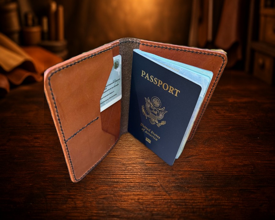 Open tan leather passport wallet with ID card and U.S. passport on the workbench