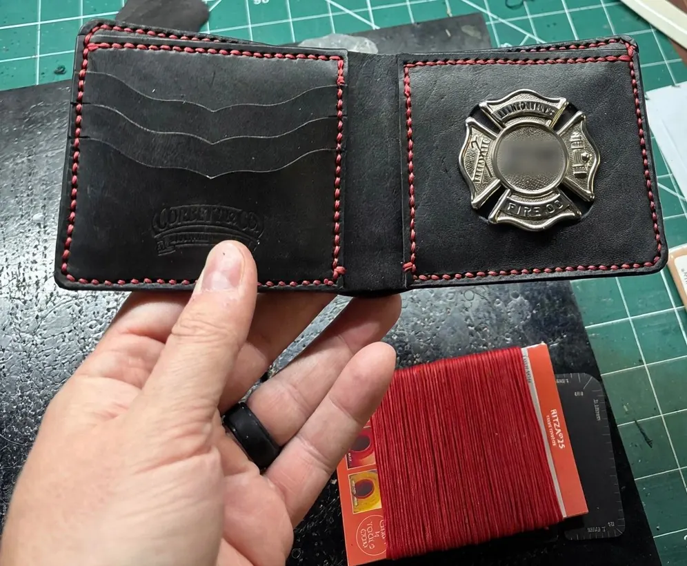 Leather badge wallet with a shield cutout and badge seated in place